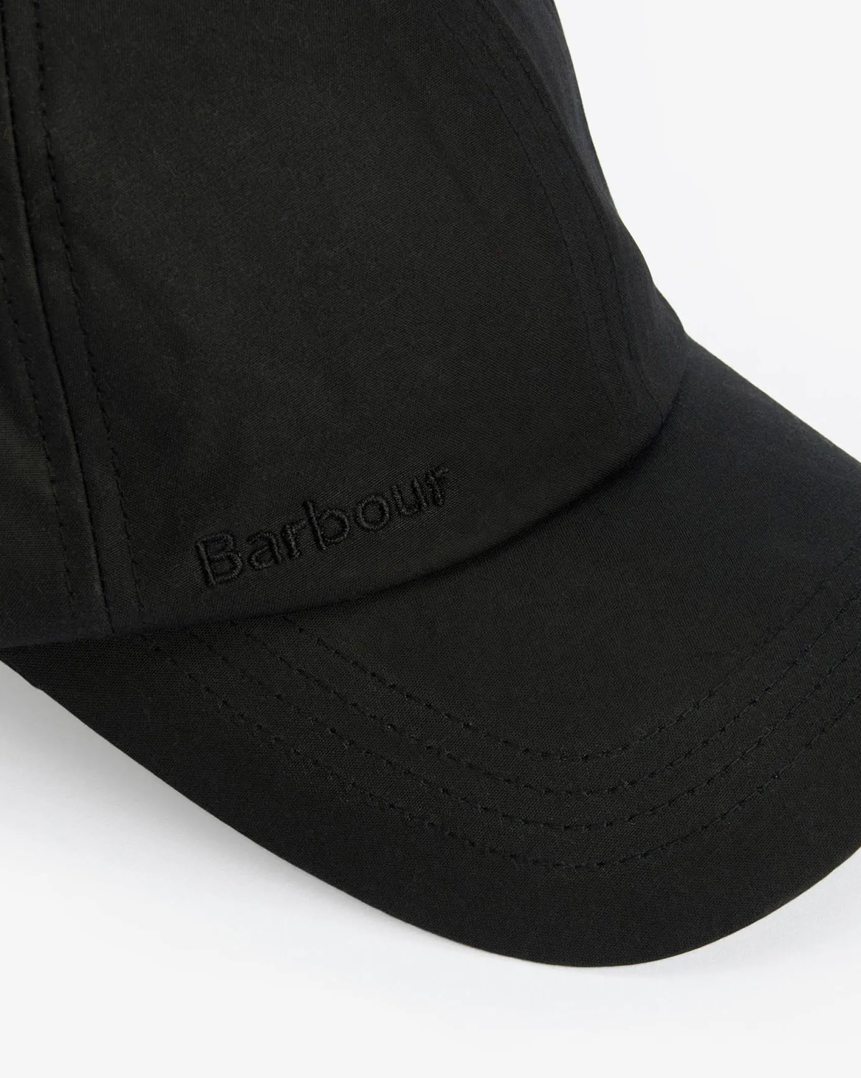 Berretto Barbour nero in cotone cerato con frontino
