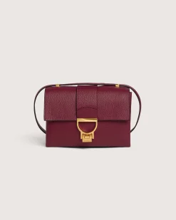 Borsa bordeaux Coccinelle Arlettis in pelle a grana grossa con patta e chiusura a battente