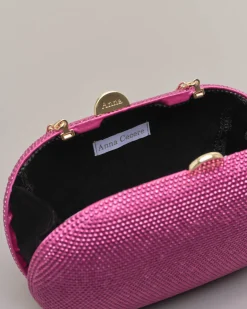 Clutch ovale fucsia con strass applicati all over e chiusura a scatto a sfera