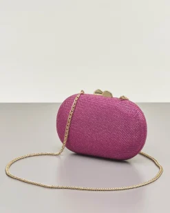Clutch ovale fucsia con strass applicati all over e chiusura a scatto a sfera