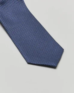 Cravatta blu in micro fantasia geometrica di misto seta e cotone