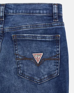 Jeans Guess slim in cotone stretch a lavaggio scuro stone washed con abrasioni