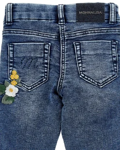 Jeans Monnalisa slim a lavaggio scuro delavé con ricami floreale e bande nere glitterate