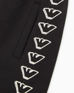 Jogger Emporio Armani Junior in felpa di cotone nera con stampa grafica aquile bianche