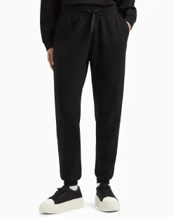 Joggers slim-fit neri in tessuto scuba con logo al fondo in strass applicati