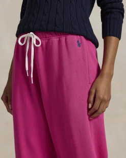 Pantaloni fucsia in felpa di cotone garzato con elastico al fondo e logo blu ricamato