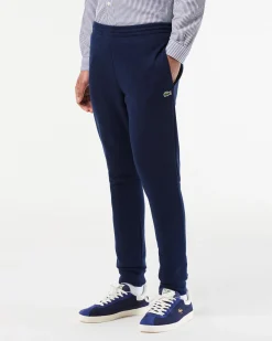 Pantaloni Lacoste blu in felpa di cotone con logo coccodrillo verde sul fianco