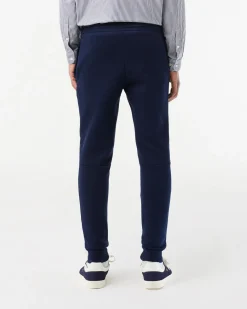 Pantaloni Lacoste blu in felpa di cotone con logo coccodrillo verde sul fianco