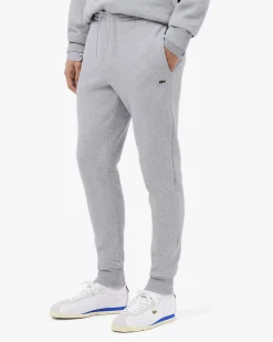 Pantaloni Lacoste grigi in felpa di cotone con logo coccodrillo verde sul fianco