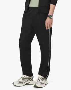 Pantaloni Lacoste neri in felpa piqué interlock di cotone con piping in contrasto