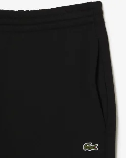 Pantaloni Lacoste neri in felpa di cotone con logo coccodrillo verde sul fianco