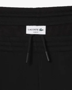 Pantaloni Lacoste neri in felpa di cotone con logo coccodrillo verde sul fianco