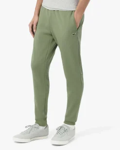 Pantaloni Lacoste verde salvia in felpa di cotone con logo coccodrillo verde sul fianco