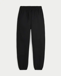 Pantaloni neri in felpa di cotone garzato con elastico al fondo e logo bianco ricamato