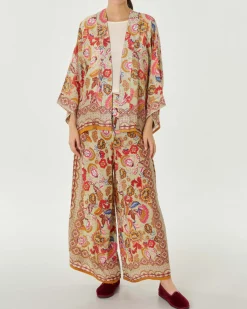 Pantaloni palazzo verde chiaro a fantasia floreale d'ispirazione indiana multicolore in cupro e viscosa