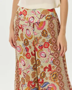 Pantaloni palazzo verde chiaro a fantasia floreale d'ispirazione indiana multicolore in cupro e viscosa