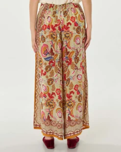 Pantaloni palazzo verde chiaro a fantasia floreale d'ispirazione indiana multicolore in cupro e viscosa