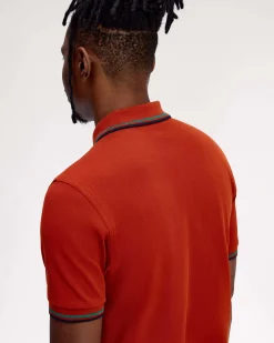 Polo Fred Perry arancione mezza manica con bordino verde acqua e blu
