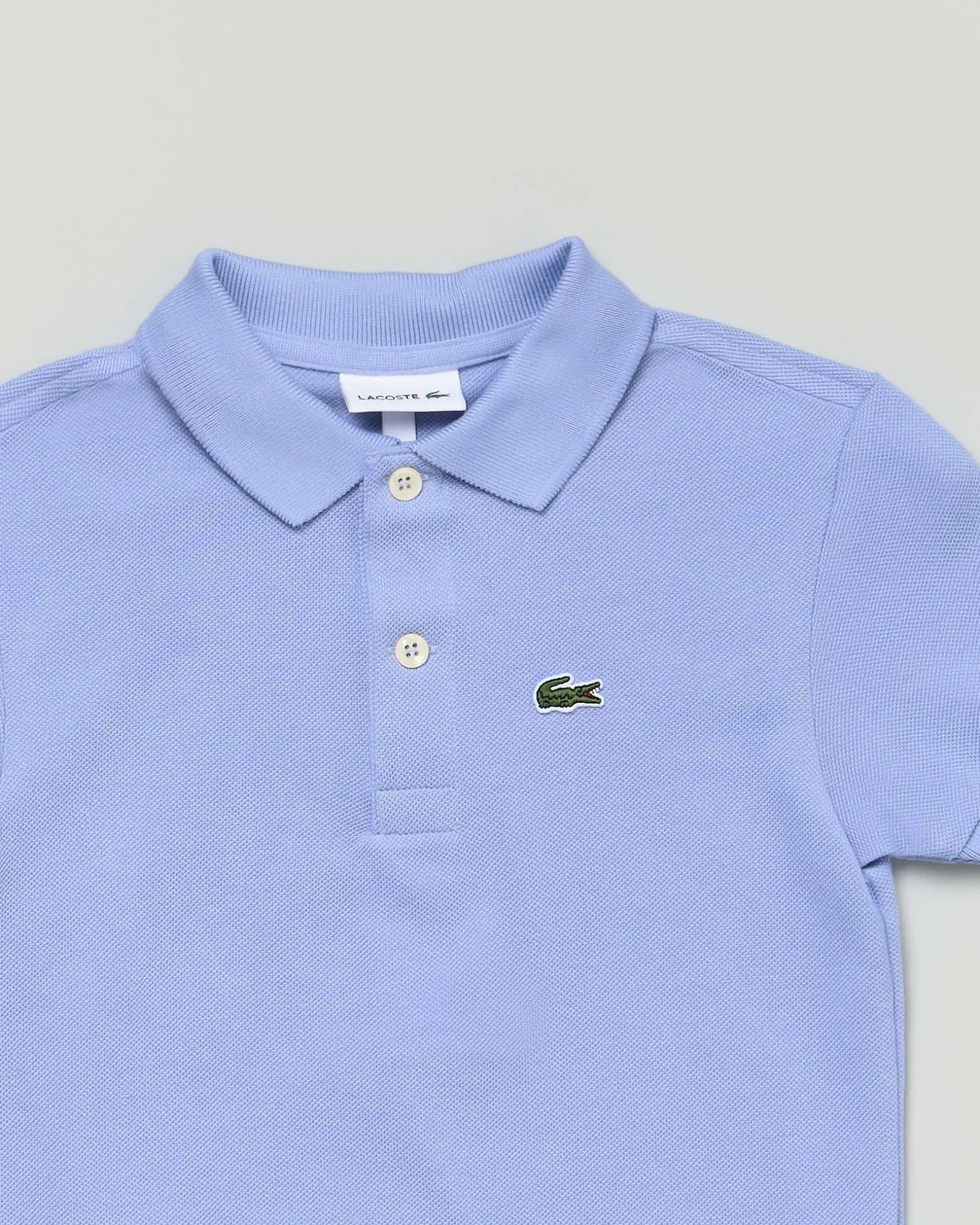 Polo Lacoste celeste piqué di puro cotone