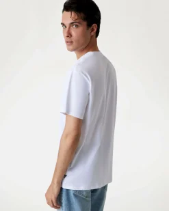 T-shirt Guess bianca in cotone con logo scritta in rilievo sul petto
