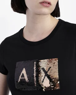 T-shirt nera Armani Exchange in cotone con logo in paillettes reversibili nel color oro